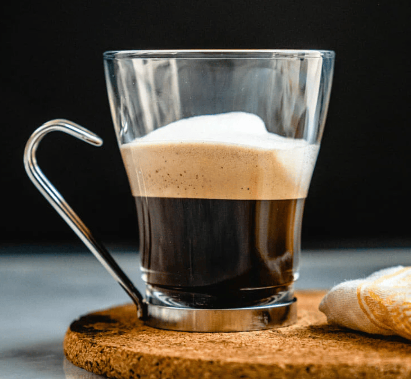 clear cup with an espresso shot and silky foam
