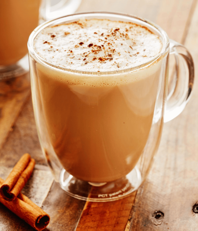 clear cup with milky brown chai latte and foam