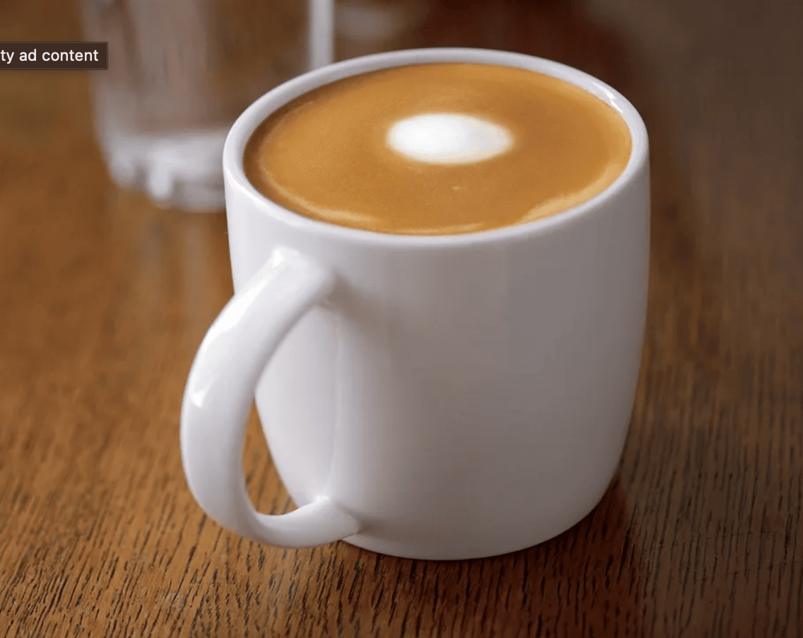 white cup with espresso and foam.