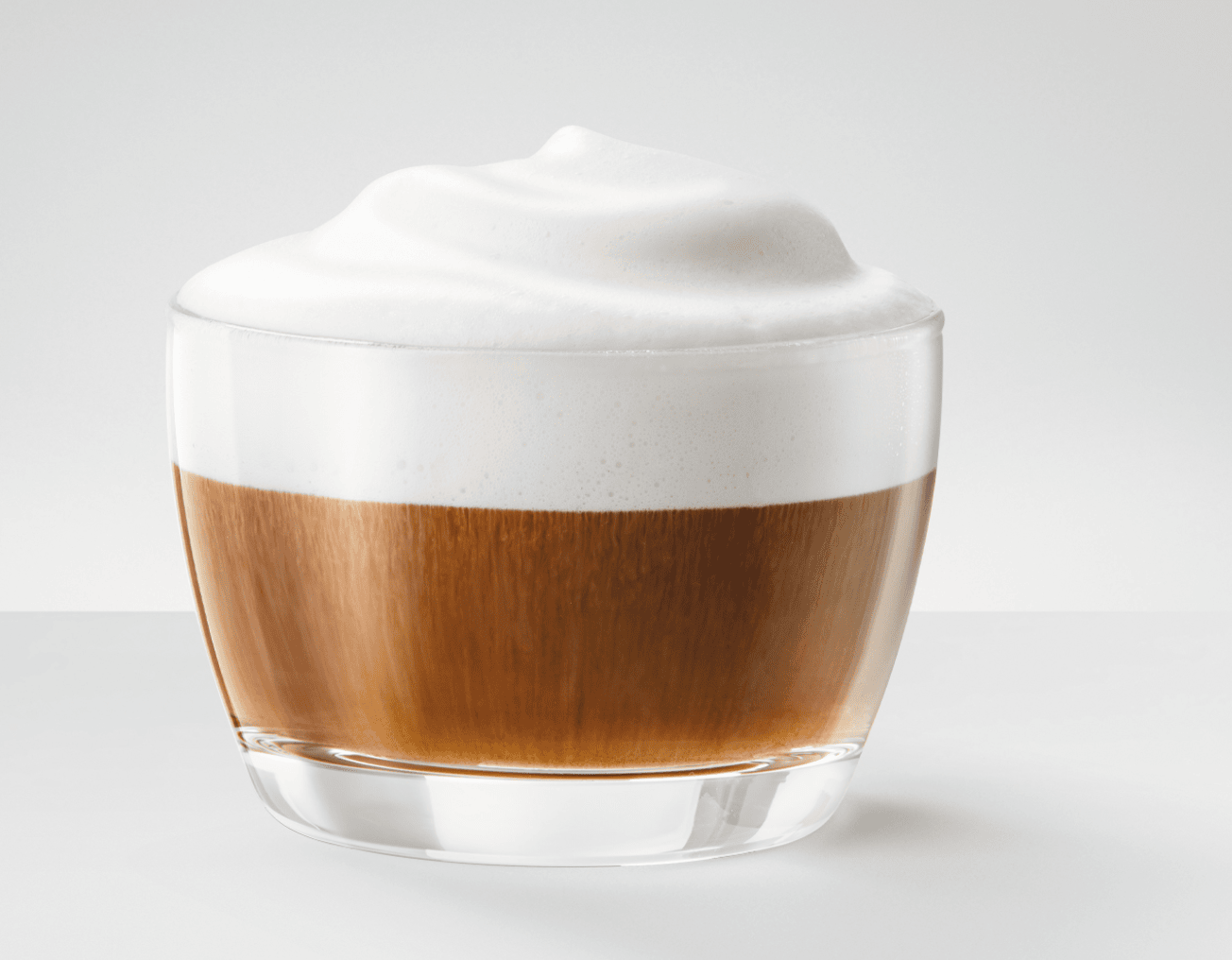 clear cup with a shot of espresso, a bit of milk, and foam