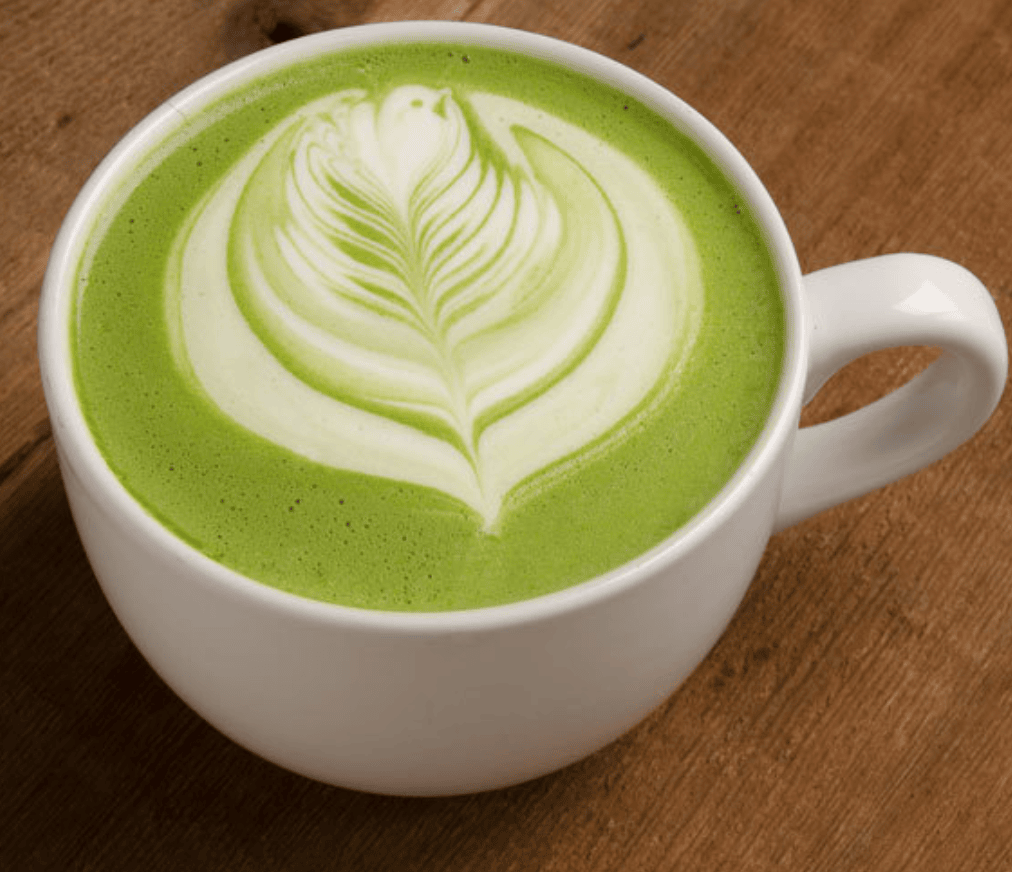 green matcha latte with a leaf design