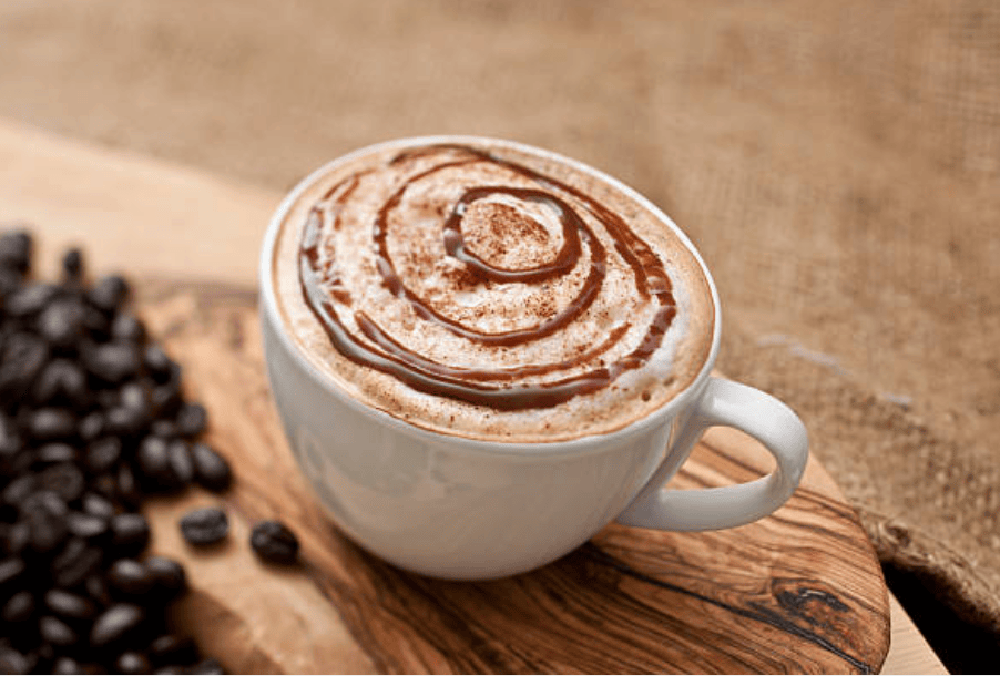 mocha latte with foam and chocolate drizzle on top
